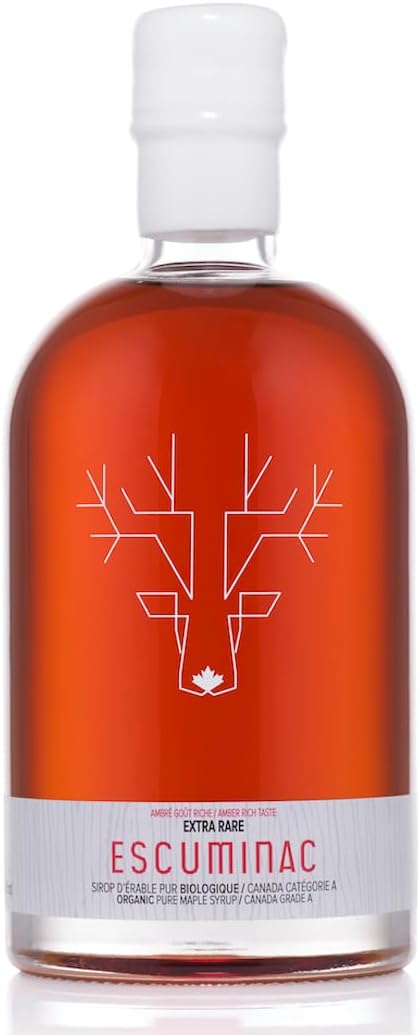 A bottle of Escuminac Extra Rare organic Canadian maple syrup, filled with rich amber syrup and sealed with a white cap. The minimalist label features a geometric white deer head with a small maple leaf at the base, emphasizing its Canadian origin and premium quality.