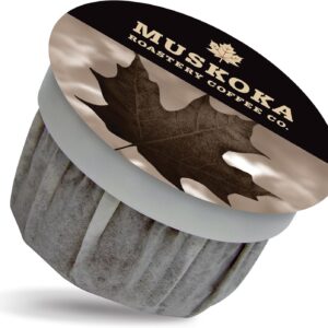 Single-serve coffee pod from Muskoka Roastery Coffee Co. featuring a sepia-toned maple leaf design on the lid and bold text reading "Muskoka Roastery Coffee Co." The packaging reflects the brand’s signature Maple Roast coffee, tying into its Canadian heritage and natural flavor profile.