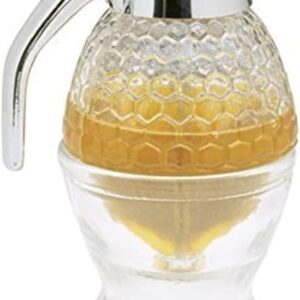 Glass maple syrup dispenser with a honeycomb-patterned top and chrome-plated handle and lid. The clear container shows golden syrup inside and sits atop a matching glass base designed to catch drips.