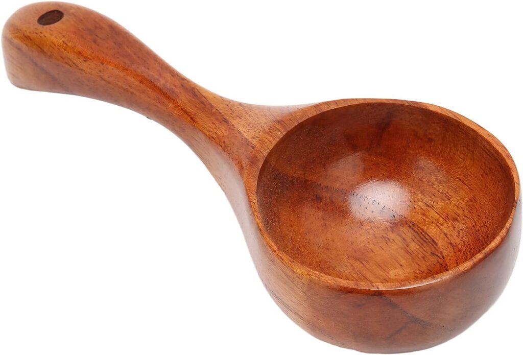 Hand-carved wooden coffee scoop with a smooth finish and rounded handle, featuring a rich natural grain and a hole for hanging. This rustic yet functional piece is a charming addition to any Canadian holiday gift guide for coffee lovers.