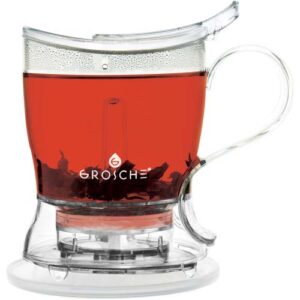 Clear Grosche tea infuser mug filled with steeping loose leaf tea, featuring a built-in filter and easy-release valve for mess-free pouring. This sleek and functional design makes it a perfect addition to any Canadian holiday gift guide for tea lovers.